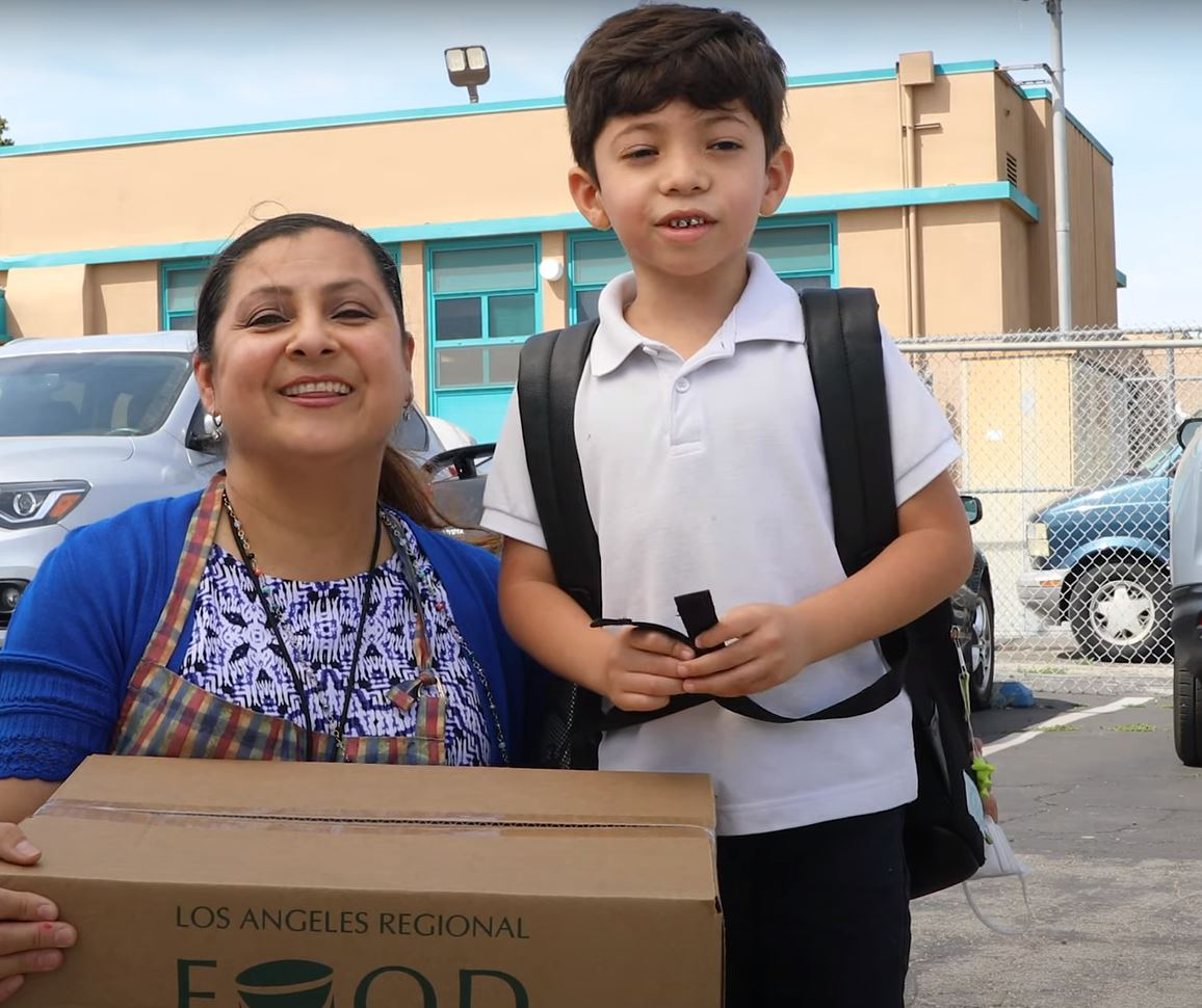 Mother and son at outdoor distribution